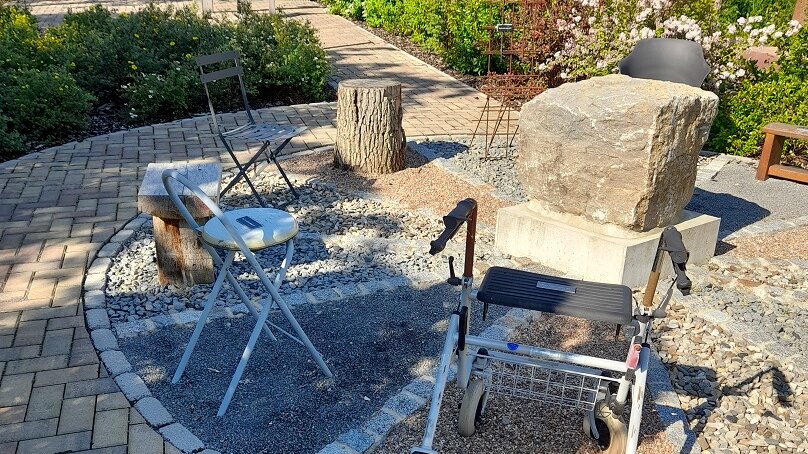 Bildausschnitt aus dem Kunstgarten mit Steinen und Sitzgelegenheiten