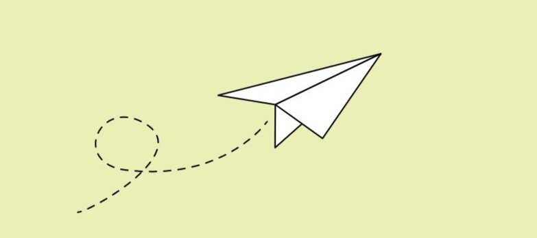 Weißer Papierflieger auf hellgrünem Hintergrund